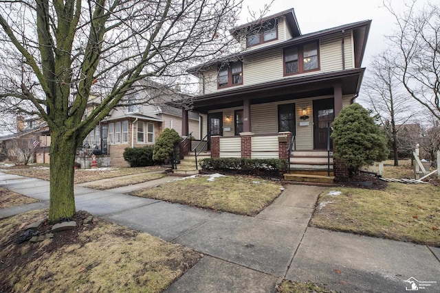 american foursquare style home with covered porch