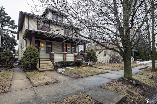 american foursquare style home featuring covered porch