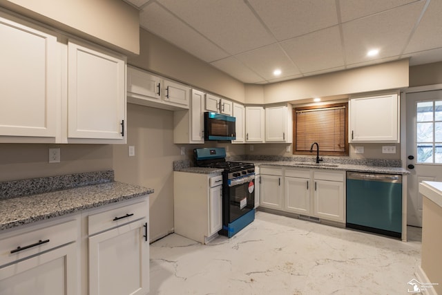 kitchen with dishwasher, white cabinets, stainless steel range with gas stovetop, and a sink