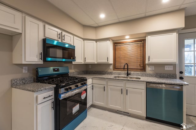 kitchen featuring white cabinetry, dishwashing machine, stainless steel range with gas cooktop, and a sink