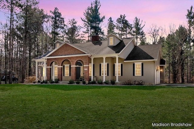 view of front of property featuring a chimney and a front lawn