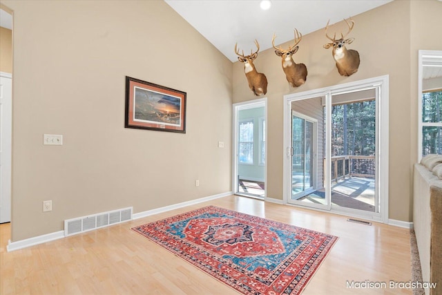 interior space featuring wood finished floors, visible vents, and baseboards