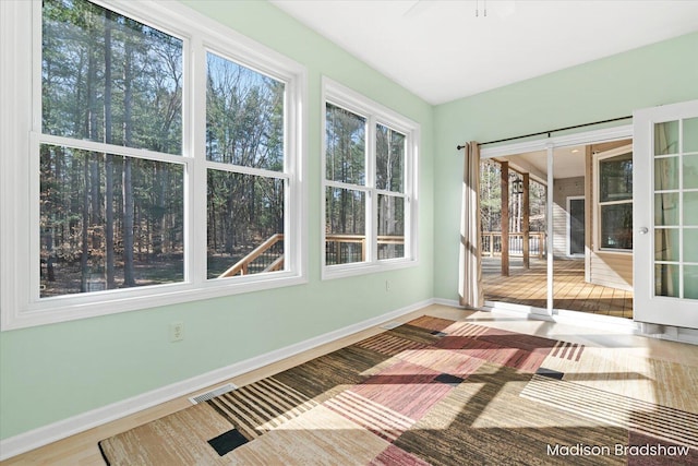 unfurnished sunroom featuring visible vents