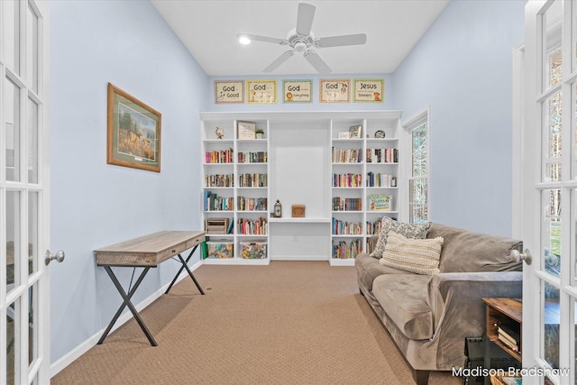 living area featuring carpet flooring, a ceiling fan, baseboards, and french doors