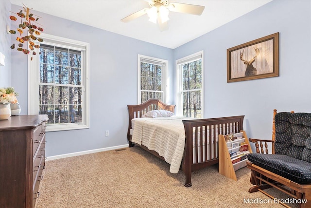 bedroom with visible vents, light colored carpet, a ceiling fan, and baseboards