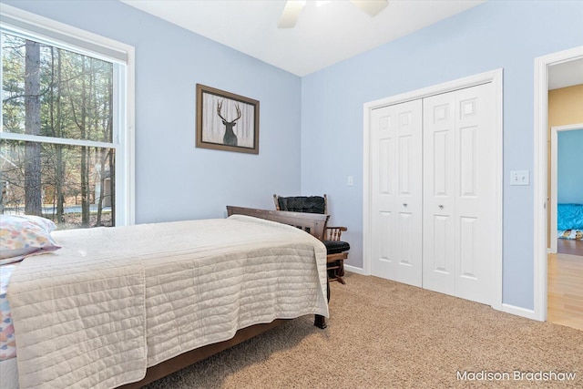 bedroom featuring a closet, ceiling fan, baseboards, and carpet