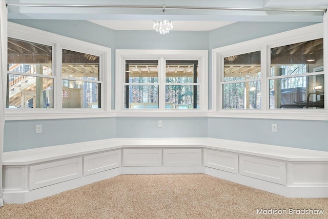 unfurnished sunroom featuring an inviting chandelier