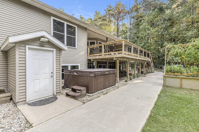 exterior space with a deck and a hot tub