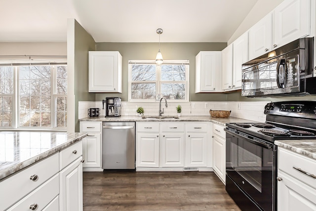 kitchen with black appliances, plenty of natural light, dark wood-style floors, and a sink