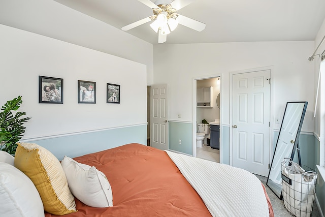 bedroom featuring lofted ceiling, a ceiling fan, and connected bathroom