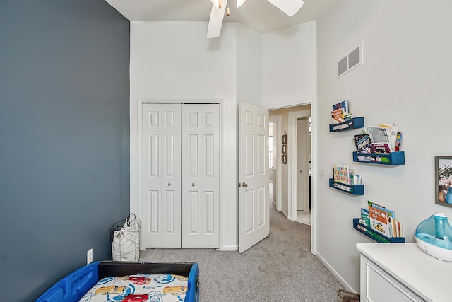 bedroom with visible vents, ceiling fan, baseboards, carpet floors, and a closet