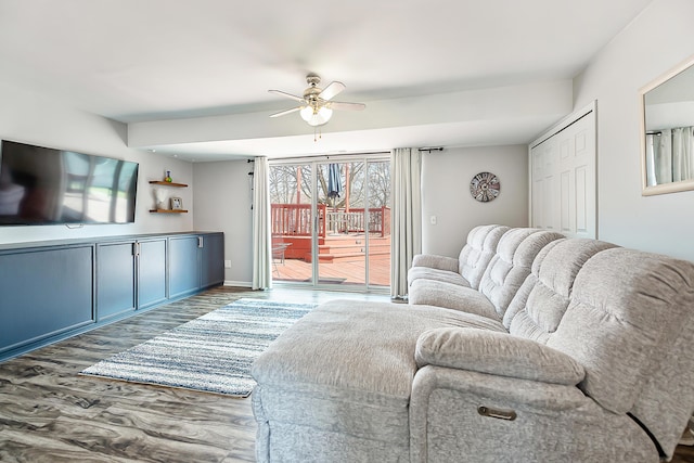 living area featuring a ceiling fan and wood finished floors