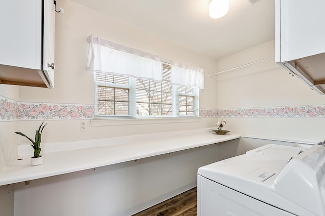 washroom featuring washer and dryer, cabinet space, and dark wood-style floors