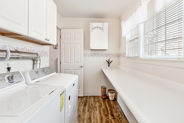 laundry room with washing machine and dryer, cabinet space, and dark wood-style flooring