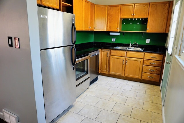 kitchen with visible vents, open shelves, a sink, stainless steel appliances, and brown cabinets