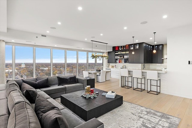 living area featuring recessed lighting, visible vents, and light wood-style flooring