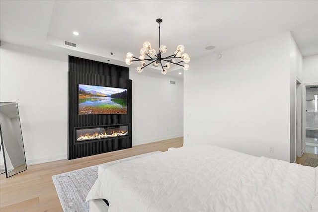 bedroom with visible vents, light wood finished floors, baseboards, an inviting chandelier, and recessed lighting