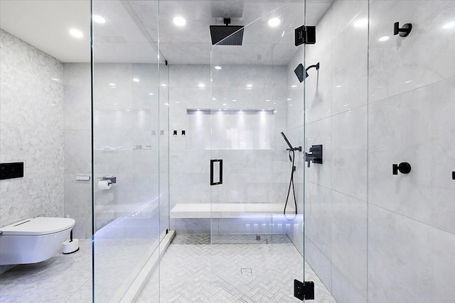 bathroom featuring toilet, tile walls, and a shower stall