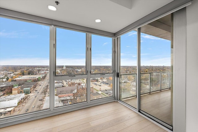 unfurnished sunroom featuring a city view