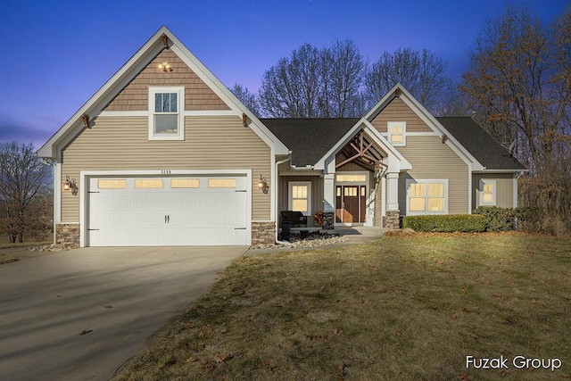 view of front of home featuring concrete driveway, a garage, stone siding, and a front lawn