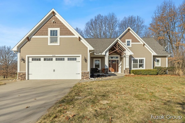 view of front facade with stone siding, concrete driveway, a garage, and a front yard