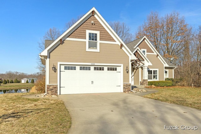 view of front of home with stone siding, a front yard, and driveway