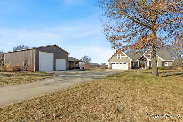 exterior space featuring a detached garage and a front lawn