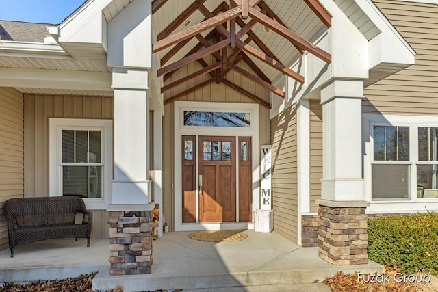 entrance to property with stone siding and covered porch