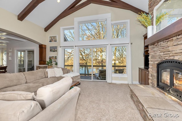 living room featuring high vaulted ceiling, beam ceiling, a fireplace, a water view, and carpet flooring