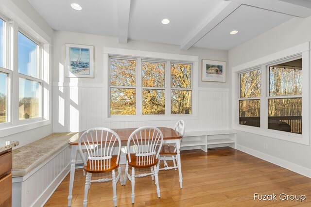 sunroom featuring beam ceiling