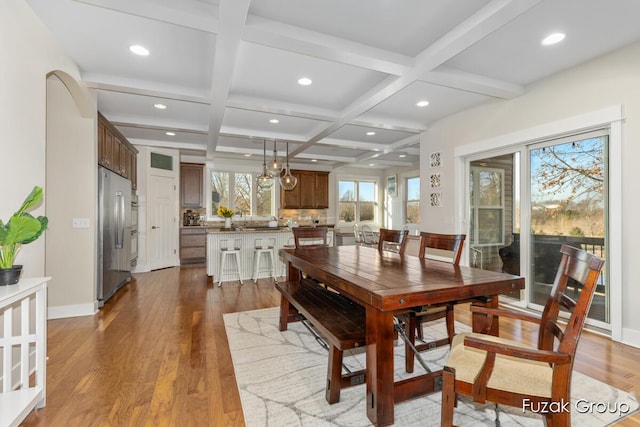 dining space featuring beam ceiling, recessed lighting, coffered ceiling, and wood finished floors