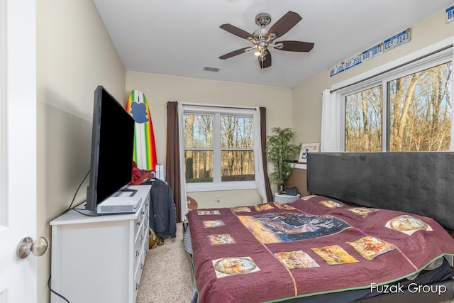 bedroom featuring visible vents, carpet, and a ceiling fan