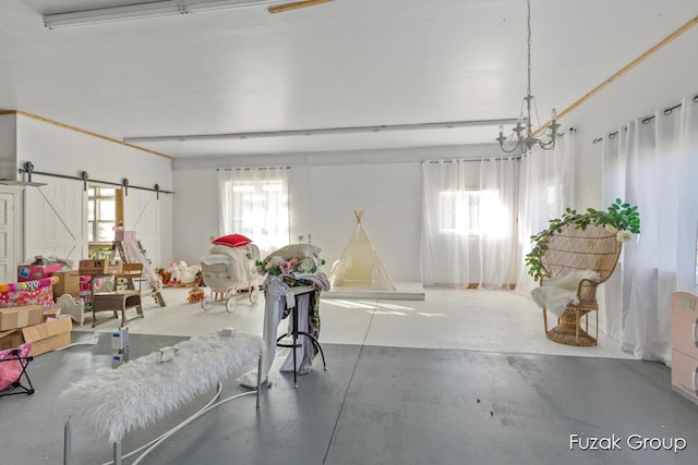 interior space featuring a barn door and concrete floors