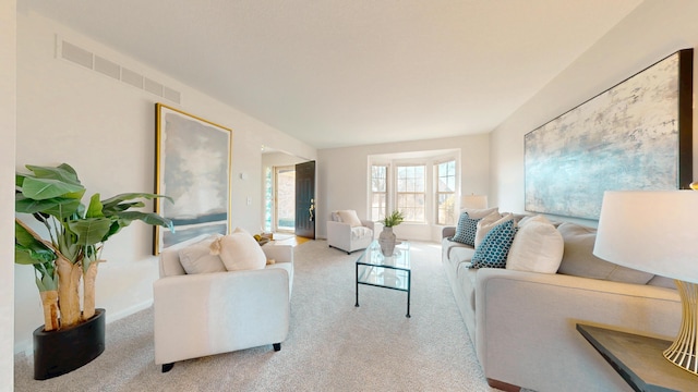 carpeted living area featuring visible vents