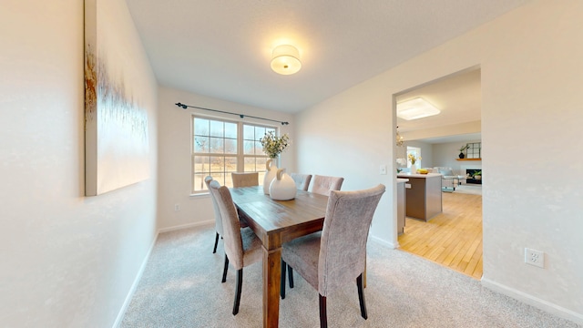 dining area with light colored carpet and baseboards