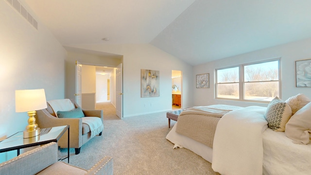 bedroom featuring visible vents, baseboards, ensuite bath, lofted ceiling, and light colored carpet