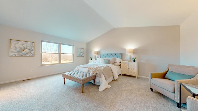 bedroom with light colored carpet, baseboards, and lofted ceiling