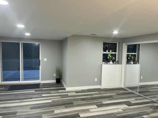 spare room featuring visible vents, recessed lighting, wood finished floors, and baseboards