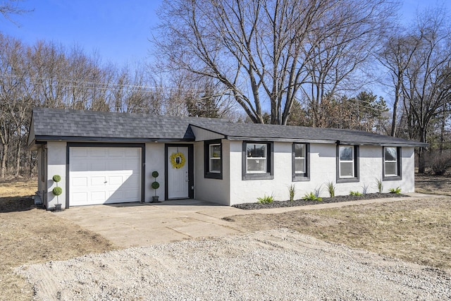 ranch-style house featuring stucco siding, roof with shingles, concrete driveway, and an attached garage