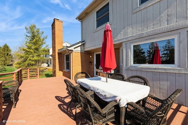 wooden terrace with outdoor dining area