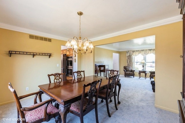 dining area featuring an inviting chandelier, crown molding, visible vents, and light carpet