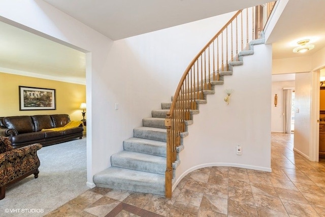 stairs with baseboards and carpet flooring