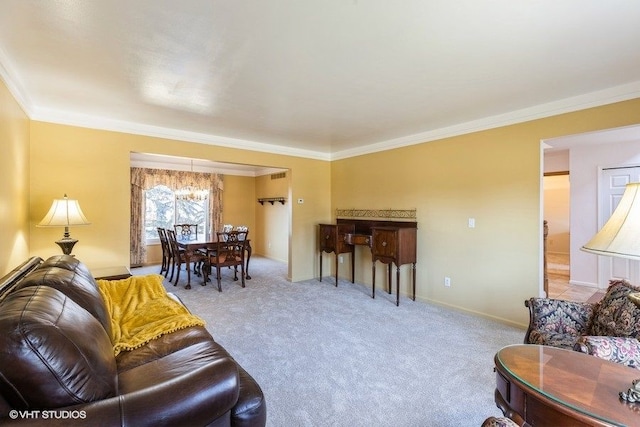 carpeted living room featuring baseboards, a chandelier, and ornamental molding