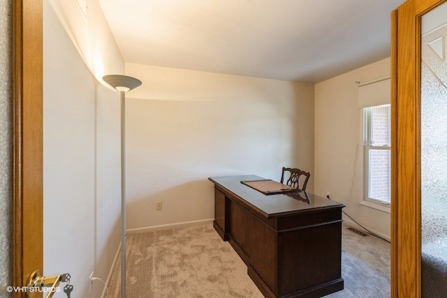 home office with visible vents, light carpet, and baseboards