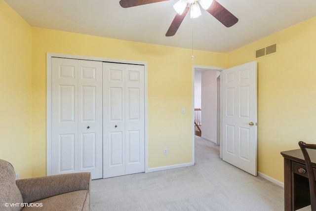 sitting room featuring visible vents, baseboards, light colored carpet, and a ceiling fan