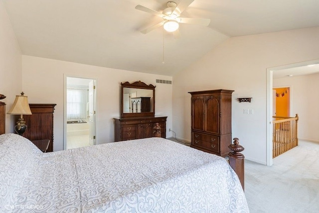 carpeted bedroom featuring baseboards, visible vents, ceiling fan, vaulted ceiling, and ensuite bathroom