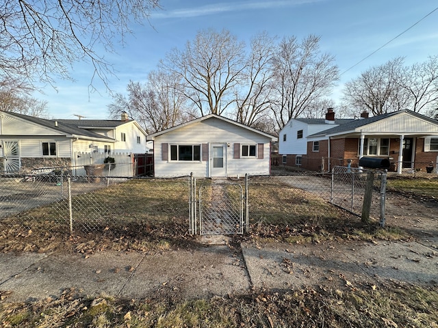 bungalow-style house with a fenced front yard and a gate