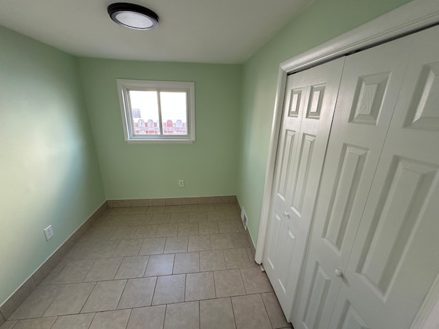 unfurnished bedroom featuring a closet and baseboards