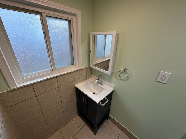 bathroom featuring tile patterned floors, vanity, and tile walls