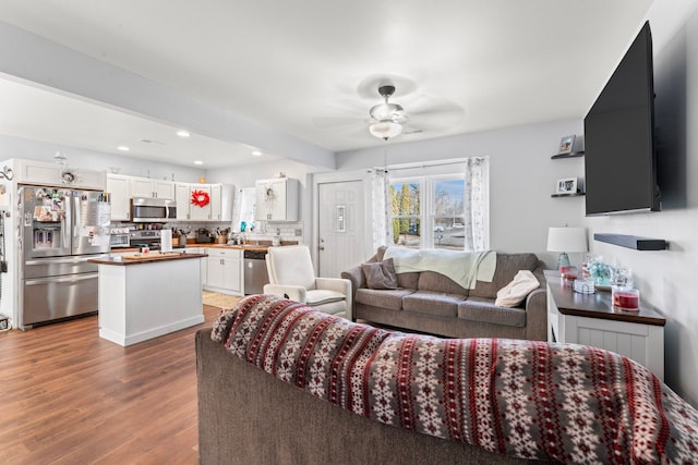 living room with recessed lighting, a ceiling fan, and wood finished floors